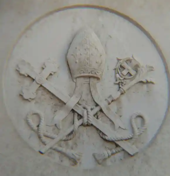 Mitre with cross and staff inside a circle